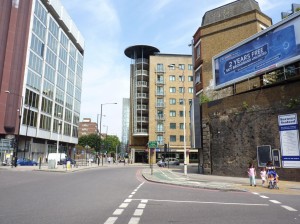 © Marilyn Roberts Mansell Street, London EC3. The Abbey of the Minoresses lay on the left of the picture, where the trees are now and covered about 2½ acres. The sisters also had a farm, which lay behind the buildings centre and right of the photograph. In Victorian times the coming of the railways swept through the area. The railway arches (right) swung round at this point towards a large goods depot where the trees are now, so it is remarkable that Anne Mowbray’s coffin survived. 