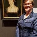 Claire Ridgway standing next to the NPG portrait of Anne Boleyn