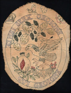 An embroidery featuring Anne Boleyn's first motto ainsi sera groigne qui groigne